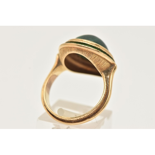 44 - A YELLOW METAL MALACHITE AND GREEN ENAMEL DRESS RING, of an oval form set with an oval cut malachite... 