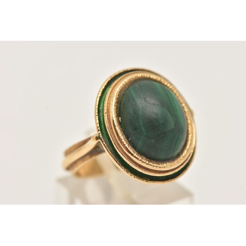 44 - A YELLOW METAL MALACHITE AND GREEN ENAMEL DRESS RING, of an oval form set with an oval cut malachite... 