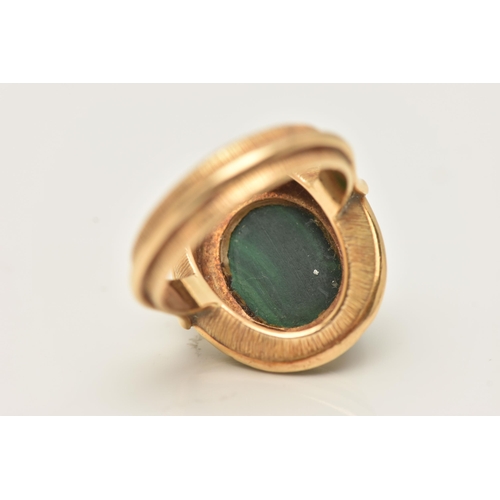 44 - A YELLOW METAL MALACHITE AND GREEN ENAMEL DRESS RING, of an oval form set with an oval cut malachite... 