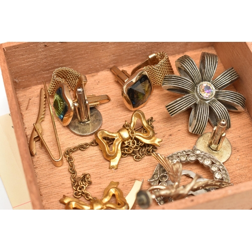 101 - A SMALL BOX OF COSTUME JEWELLERY, to include a double bow brooch, a clip and two pairs of cufflinks,