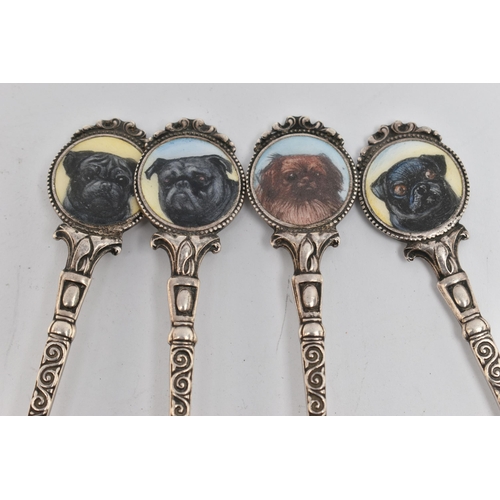 105 - FOUR SILVER TEASPOONS, each with a painted round terminal depicting dogs, the scrolling stems and po... 