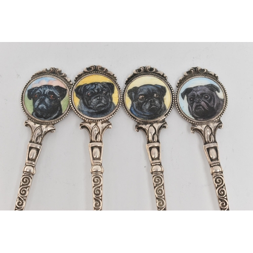 106 - FOUR SILVER TEASPOONS, each with a painted round terminal depicting dogs, the  scrolling stems and p... 