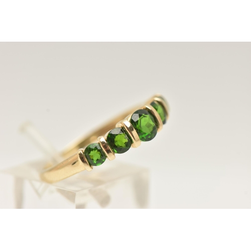 58 - A 9CT GOLD GEM SET RING, set with a row of five graduated circular cut chrome diopside, tension set ... 