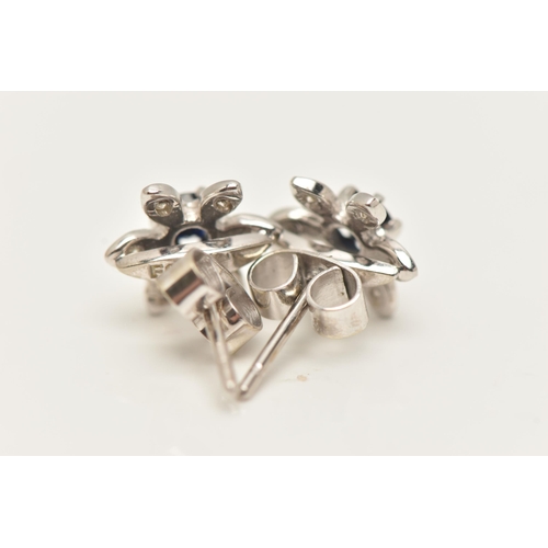 64 - A PAIR OF 18CT WHITE GOLD SAPPHIRE AND DIAMOND CLUSTER STUD EARRINGS, each of flower design with a c... 