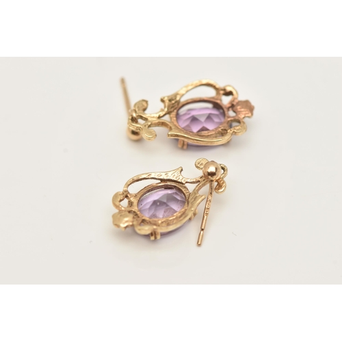 66 - A PAIR OF 9CT GOLD AMETHYST DROP EARRINGS, each designed as an oval amethyst in claw settings to the... 