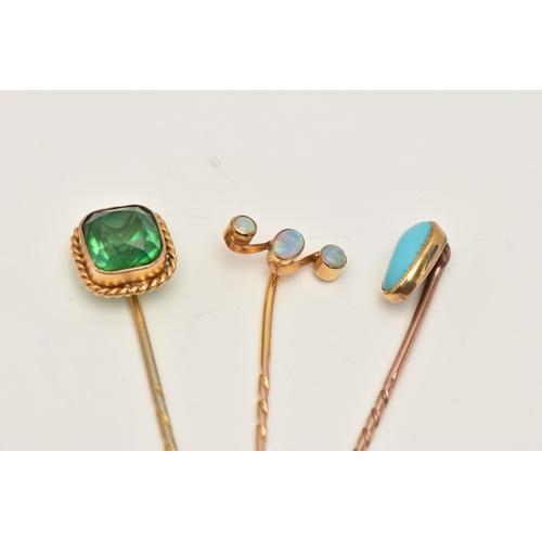 67 - THREE ANTIQUE STICKPINS, to include a three stone opal cabochon stickpin, an oval turquoise cabochon... 