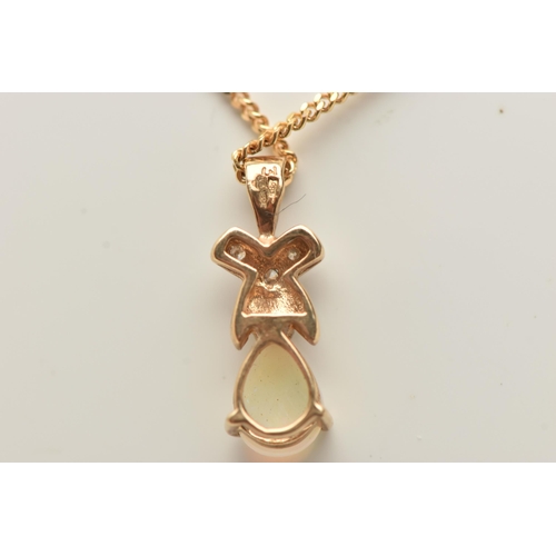 72 - A 9CT GOLD OPAL AND DIAMOND PENDANT AND CHAIN, designed as a pear shape opal cabochon beneath a bril... 