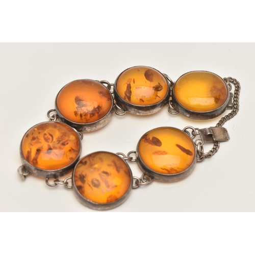 80 - AN AMBER BRACELET, the links designed as circular cabochons of heat treated amber in collet settings... 