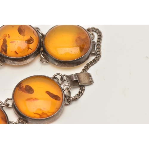 80 - AN AMBER BRACELET, the links designed as circular cabochons of heat treated amber in collet settings... 