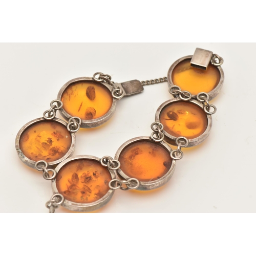 80 - AN AMBER BRACELET, the links designed as circular cabochons of heat treated amber in collet settings... 