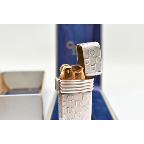 97 - A 'CHRISTIAN DIOR' AND A 'RONSON' LIGHTER, a white metal lighter with repeating 'C D' pattern, signe... 