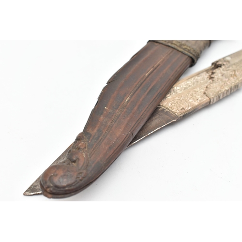 99 - A SRI LANKAN PIHA KAETTA DAGGER, carved scrolling detail to the handle with white metal embellishmen... 