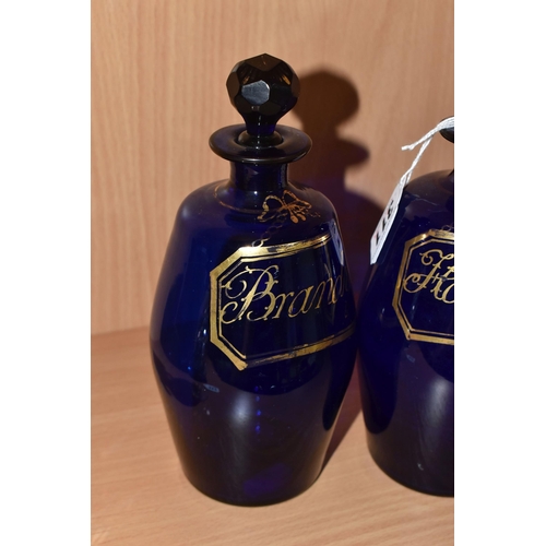 311 - A SET OF THREE EARLY 19TH CENTURY BRISTOL BLUE GLASS BARREL SHAPED DECANTERS, with original faceted ... 