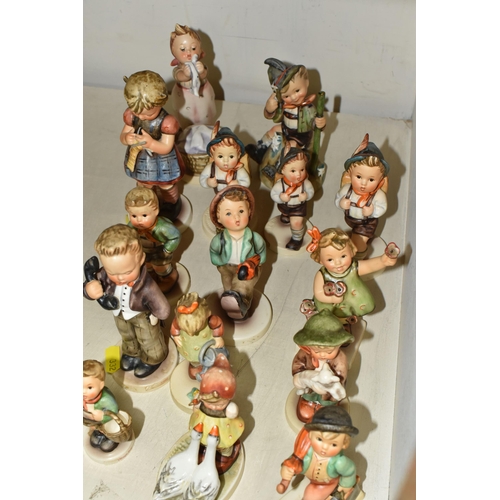 332 - A GROUP OF FIFTEEN HUMMEL FIGURES BY W. GOEBEL to include 'Merry Wanderer' 112/09, 'Goose Girl' 473/... 