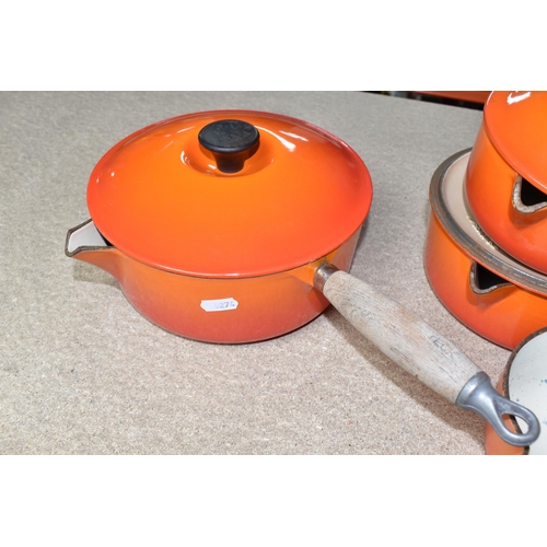 361 - FOUR LE CREUSET CAST IRON SAUCEPANS, in orange enamel with pouring lips and wooden handles, diameter... 