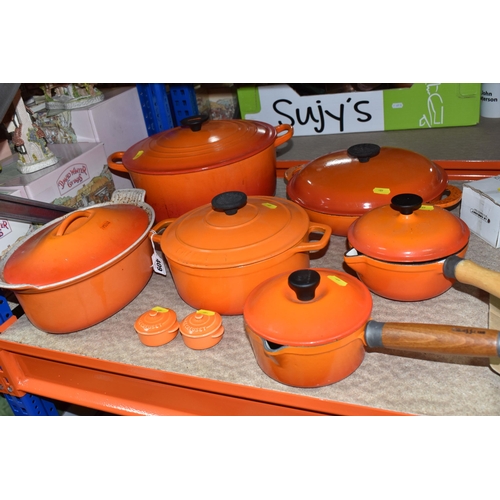 409 - LE CREUSET CAST IRON SAUCEPANS/ CASSEROLE POTS AND CRUET SET, in orange enamel outer finish and crea... 