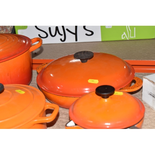 409 - LE CREUSET CAST IRON SAUCEPANS/ CASSEROLE POTS AND CRUET SET, in orange enamel outer finish and crea... 