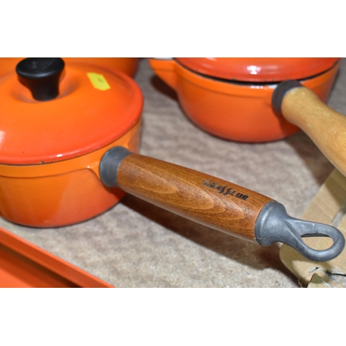 409 - LE CREUSET CAST IRON SAUCEPANS/ CASSEROLE POTS AND CRUET SET, in orange enamel outer finish and crea... 