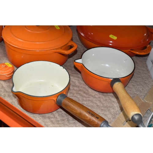 409 - LE CREUSET CAST IRON SAUCEPANS/ CASSEROLE POTS AND CRUET SET, in orange enamel outer finish and crea... 