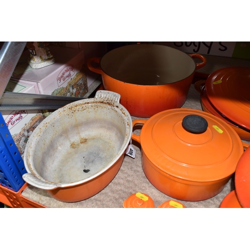 409 - LE CREUSET CAST IRON SAUCEPANS/ CASSEROLE POTS AND CRUET SET, in orange enamel outer finish and crea... 