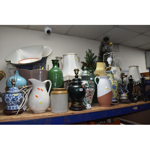 423 - A LARGE QUANTITY OF LAMPS AMD DECORATIVE ORNAMENTS to include approximately fourteen lamps of assort... 