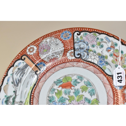 431 - A JAPANESE PORCELAIN CHARGER, painted with scroll-like panels depicting a lakeside scene with mounta... 