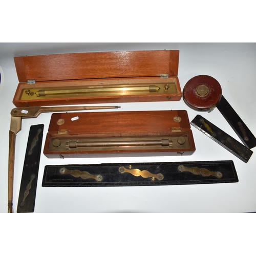 502 - A BOX OF TECHNICAL DRAWING EQUIPMENT, comprising two cased brass parallel rolling rules, four parall... 