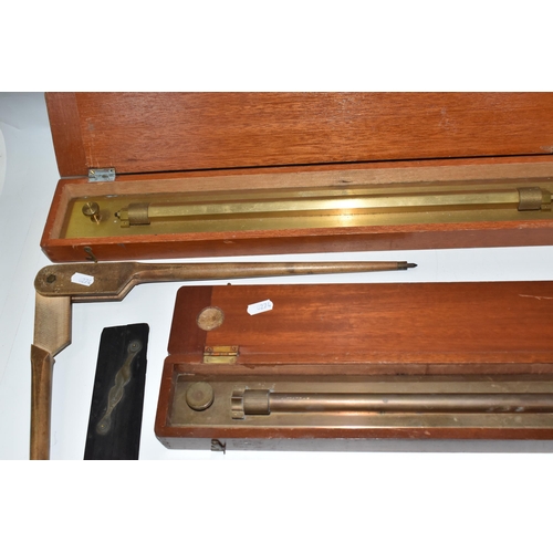 502 - A BOX OF TECHNICAL DRAWING EQUIPMENT, comprising two cased brass parallel rolling rules, four parall... 