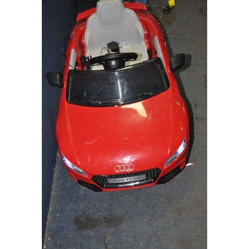 1083 - A CHILDS RIDE ON ELECTRIC CAR in the form of an Audi TT RS line with USB input and power supply (PAT... 