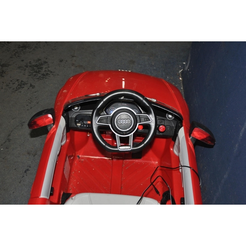 1083 - A CHILDS RIDE ON ELECTRIC CAR in the form of an Audi TT RS line with USB input and power supply (PAT... 