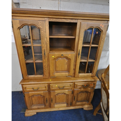 1201 - A LATE 20TH CENTURY OAK EIGHT PIECE LOUNGE SUITE, comprising an oval extending table, with a single ... 