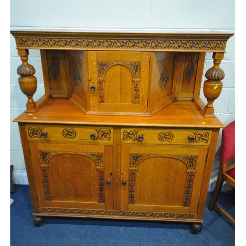 1211 - A 20TH CENTURY OAK DRAW LEAF DINING TABLE, raised on carved bulbous supports, shaped feet, united by... 