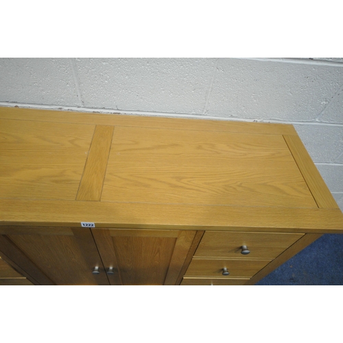 1222 - MORRIS FURNITURE COMPANY, A MODERN SOLID OAK SIDEBOARD, fitted with six drawers, flanking double cup... 