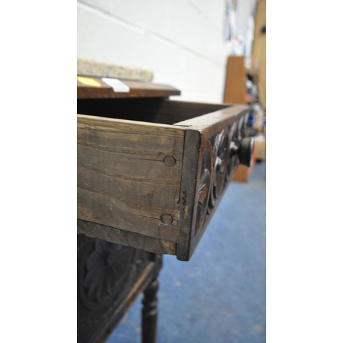 1230 - A 20TH CENTURY OAK POT CUPBOARD, with a single drawer, above a cupboard door, with geometric carved ... 