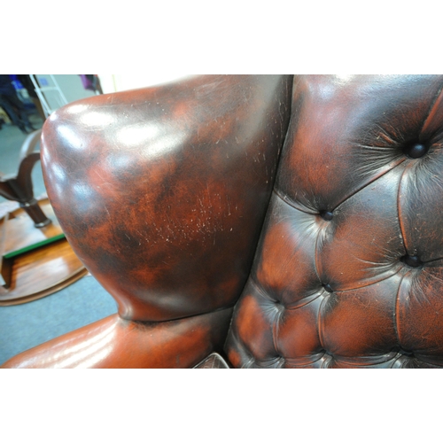 1241 - AN OXBLOOD BUTTONED LEATHER CHESTERFIELD WINGBACK ARMCHAIR, with scrolled armrests, width 87cm x dep... 