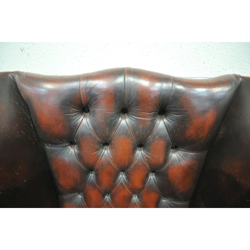 1241 - AN OXBLOOD BUTTONED LEATHER CHESTERFIELD WINGBACK ARMCHAIR, with scrolled armrests, width 87cm x dep... 