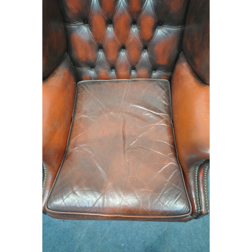 1241 - AN OXBLOOD BUTTONED LEATHER CHESTERFIELD WINGBACK ARMCHAIR, with scrolled armrests, width 87cm x dep... 