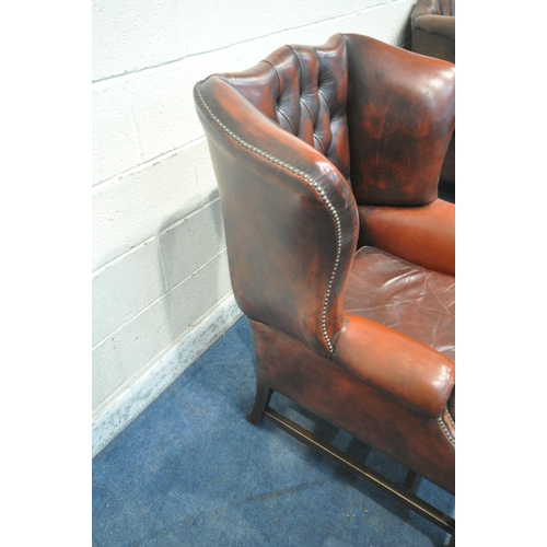 1241 - AN OXBLOOD BUTTONED LEATHER CHESTERFIELD WINGBACK ARMCHAIR, with scrolled armrests, width 87cm x dep... 