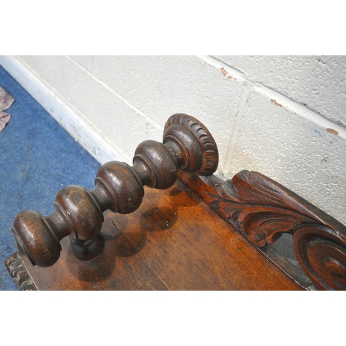 1243 - AN EARLY 20TH CENTURY OAK GOTHIC HALL BENCH, with turned armrests, scrolled backrest, with a central... 