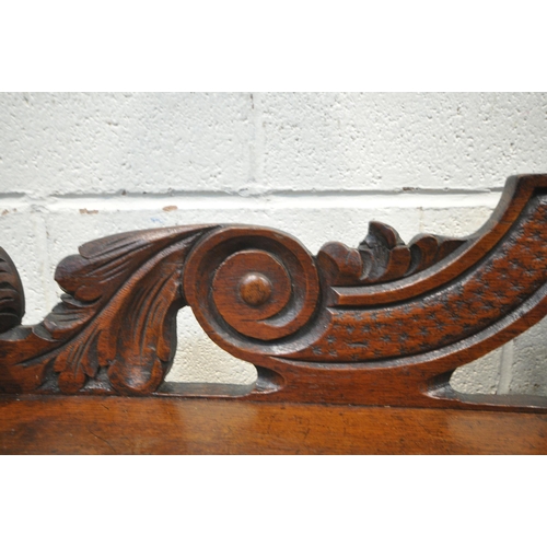 1243 - AN EARLY 20TH CENTURY OAK GOTHIC HALL BENCH, with turned armrests, scrolled backrest, with a central... 