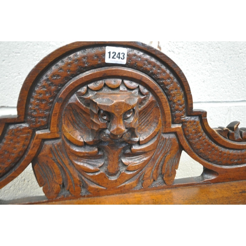 1243 - AN EARLY 20TH CENTURY OAK GOTHIC HALL BENCH, with turned armrests, scrolled backrest, with a central... 