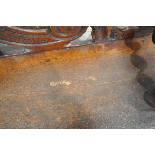 1243 - AN EARLY 20TH CENTURY OAK GOTHIC HALL BENCH, with turned armrests, scrolled backrest, with a central... 