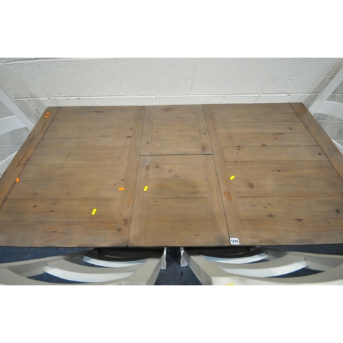 1249 - A PARTIALLY PAINTED RECLAIMED WOODEN EXTENDING TABLE, with a single fold out leaf, raised on square ... 