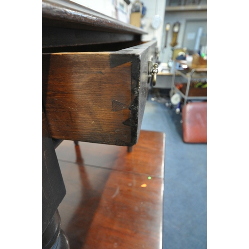 1256 - AN EARLY 20TH CENTURY MAHOGANY DROP LEAF TABLE, raised on turned legs, open width 147cm x closed wid... 