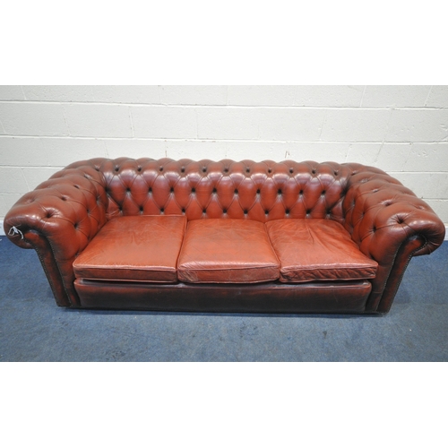 1263 - AN OXBLOOD LEATHER CHESTERFIELD THREE SEATER SOFA, with buttoned back and armrests, length 230cm x d... 