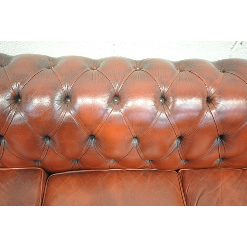 1263 - AN OXBLOOD LEATHER CHESTERFIELD THREE SEATER SOFA, with buttoned back and armrests, length 230cm x d... 