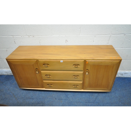 1275 - LUCIAN ERCOLANI, AN ERCOL MID CENTURY ELM SIDEBOARD, fitted with two cupboard doors, flanking three ... 