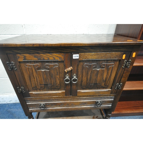 1278 - A JAYCEE OAK DOUBLE DOOR CABINET, with a single drawer, raised on turned supports, united by an unde... 