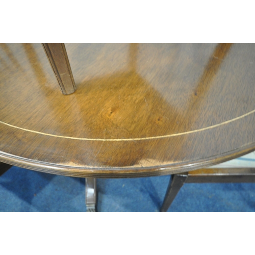 1279 - A 20TH CENTURY MAHOGANY OVAL EXTENDING DINING TABLE, with one additional leaf, raised on turned supp... 