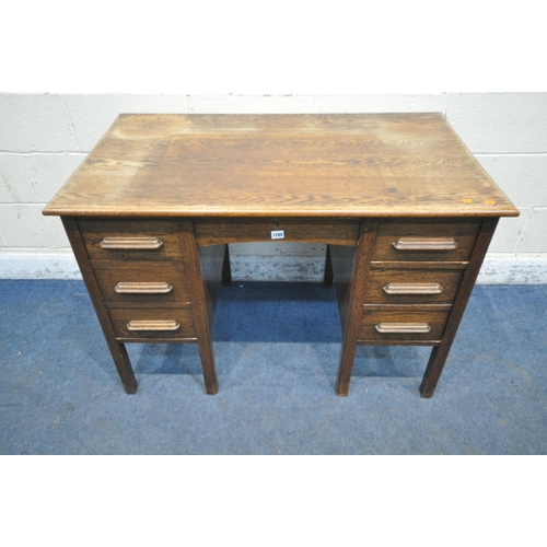 1280 - AN EARLY 20TH CENTURY OAK KNEEHOLE DESK, fitted with seven assorted drawers, width 115cm x depth 67c... 